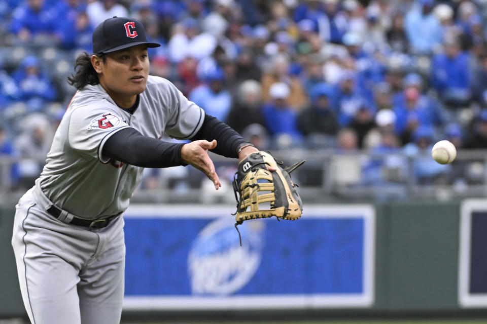 Cleveland Guardians second baseman Yu Chang tosses the ball to first for an out on the Kansas City Royals' Nicky Lopez during the eighth inning of a baseball game, Thursday, April 7, 2022 in Kansas City, Mo. (AP Photo/Reed Hoffmann)