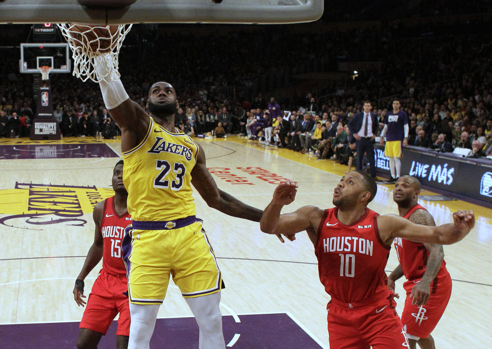 Los Angeles Lakers' LeBron James (23) dunks past Houston Rockets' Eric Gordon (10) during the second half of an NBA basketball game Thursday, Feb. 21, 2019, in Los Angeles. (AP Photo/Marcio Jose Sanchez)