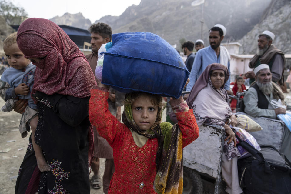 Afghan refugees return to Afghanistan through the Torkham Pakistan-Afghanistan border, in Torkham, Afghanistan, Friday, Nov. 3, 2023. A huge number of Afghan refugees entered the Torkham border to return home hours before the expiration of a Pakistani government deadline for those who are in the country illegally to leave or face deportation. (AP Photo/Ebrahim Noroozi)