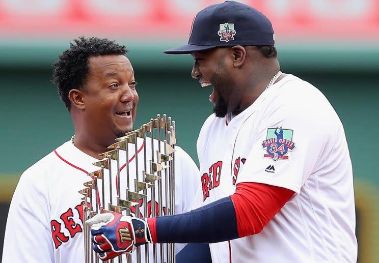 Pedro Martinez (left) and David Ortiz share the World Series trophy during a ceremony celebrating Ortiz's career. (Getty Images)