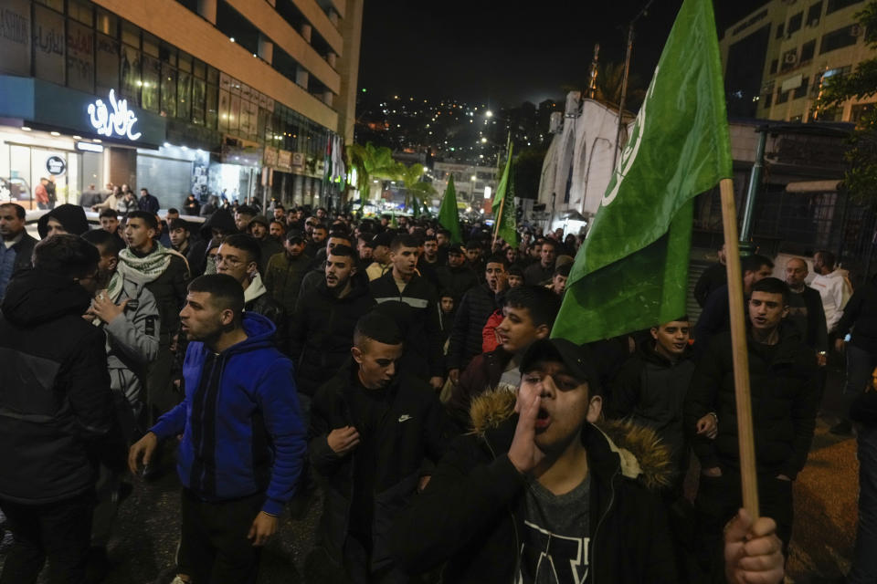 Palestinian demonstrators wave Hamas flags and shout slogans during a protest following the killing of top Hamas official Saleh Arouri in Beirut, in the West Bank city of Nablus on Tuesday, Jan. 2, 2024. Arouri, the No. 2 figure in Hamas, was killed in an explosion blamed on Israel. He is the highest-ranked Hamas figure to be killed in the nearly three-month war between Israel and Hamas. (AP Photo/Majdi Mohammed)