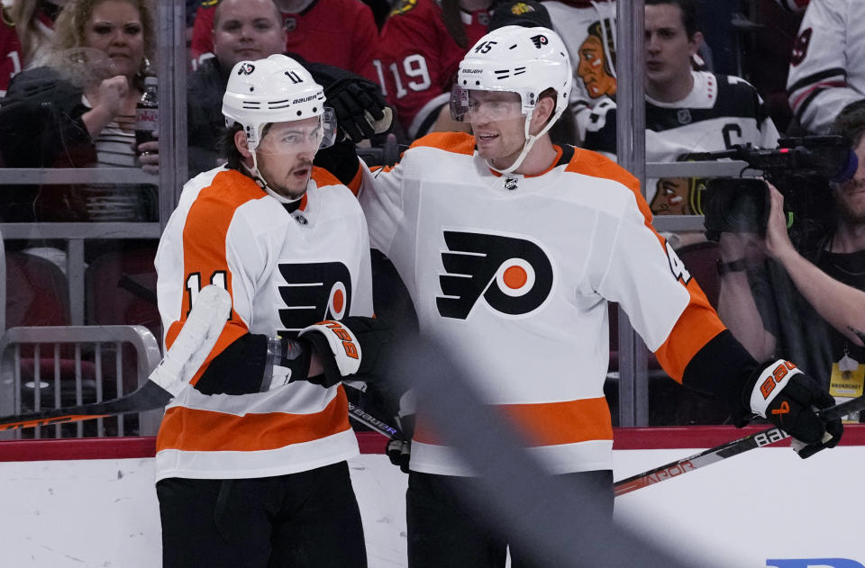 Philadelphia Flyers right wing Travis Konecny, left, celebrates his goal against the Chicago Blackhawks with defenseman Cam York during the first period of an NHL hockey game in Chicago, Thursday, April 13, 2023. (AP Photo/Nam Y. Huh)