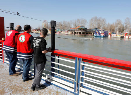 FILE PHOTO: Iraqi rescue team members are seen at the site where an overloaded ferry sank in the Tigris river near Mosul, Iraq March 22, 2019. REUTERS/Khalid al-Mousily/File Photo