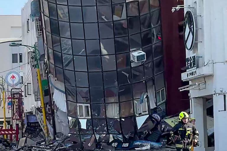 Esta captura de pantalla tomada de un video UGC de un usuario conocido como Way muestra a un bombero pasando corriendo por un edificio dañado en Hualien