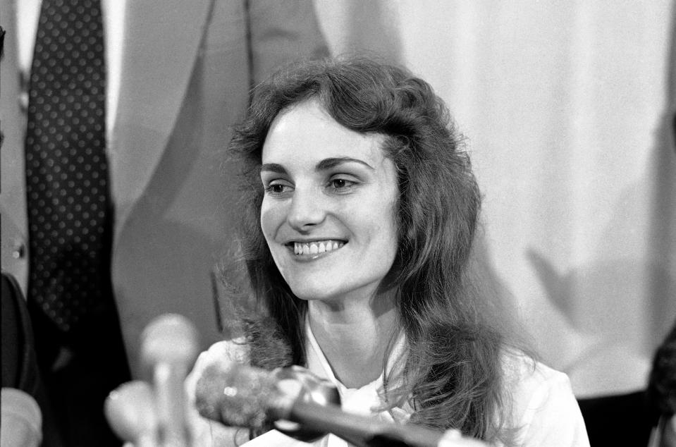 FILE- Patricia “Patty” Hearst smiles at a press conference in San Francisco, Nov. 19, 1976. The newspaper heiress was kidnapped at gunpoint 50 years ago Sunday, Feb. 4, 2024, by the Symbionese Liberation Army, a little-known armed revolutionary group. The 19-year-old college student's infamous abduction in Berkeley, Cali., led to Hearst joining forces with her captors for a 1974 bank robbery that earned her a prison sentence. Hearst, granddaughter of wealthy newspaper magnate William Randolph Hearst, will turn 70 on Feb. 20. (AP Photo/File)