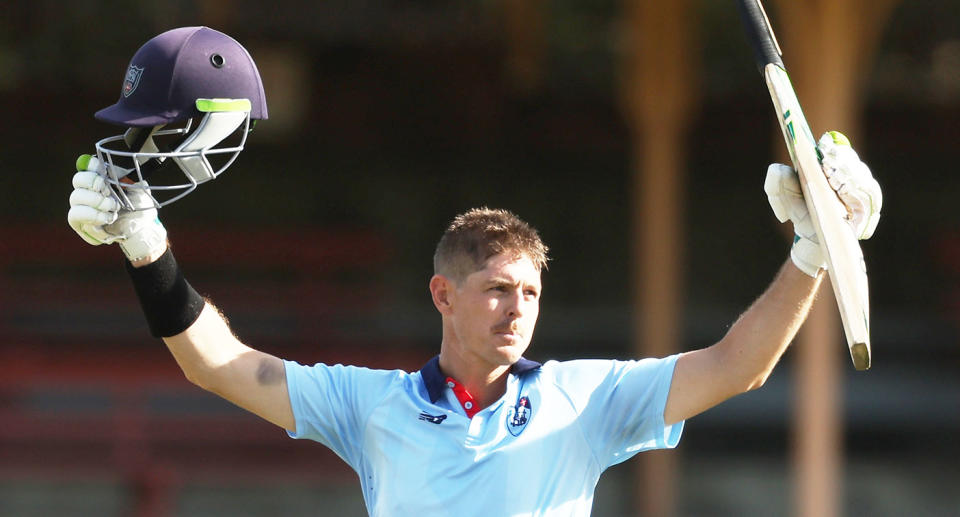 Pictured here, Daniel Hughes raises his bat after a century for NSW.