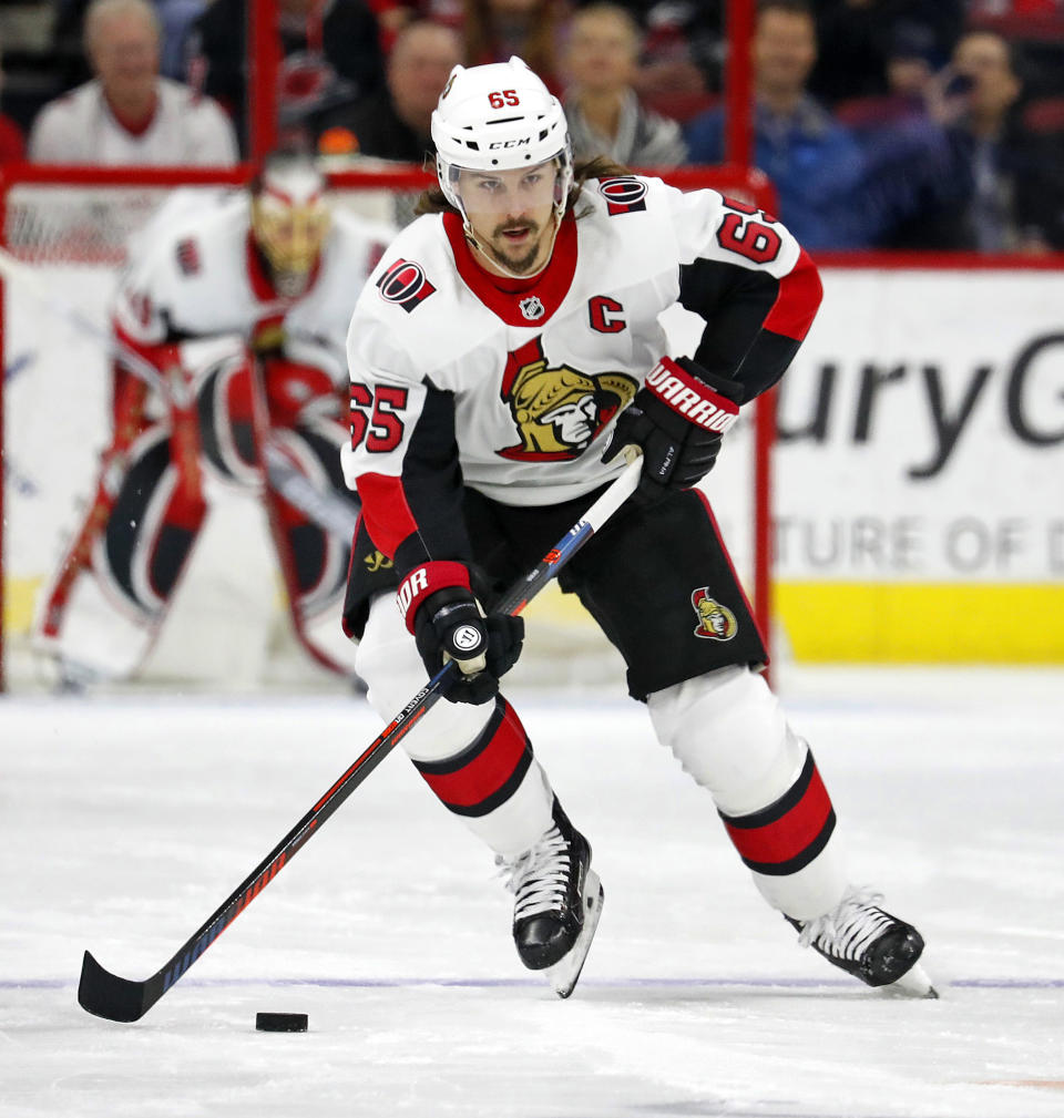 FILE - In this Jan. 30, 2018, file photo, Ottawa Senators' Erik Karlsson (65) moves the puck against the Carolina Hurricanes during the first period of an NHL hockey game in Raleigh, N.C. The San Jose Sharks have acquired two-time Norris Trophy-winning defenseman Erik Karlsson from the Senators, the teams announced Thursday, Sept. 13, 2018. (AP Photo/Karl B DeBlaker, File)