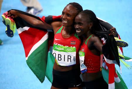 2016 Rio Olympics - Athletics - Final - Women's 5000m Final - Olympic Stadium - Rio de Janeiro, Brazil - 19/08/2016. Hellen Obiri (KEN) of Kenya and Vivian Cheruiyot (KEN) of Kenya celebrate. REUTERS/David Gray