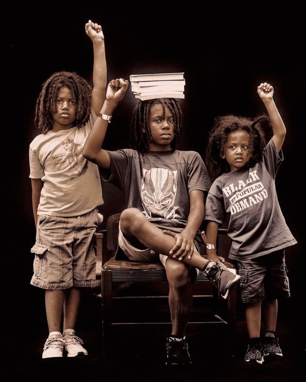 Three brothers stand for a portrait during a Juneteenth celebration in West Philadelphia.