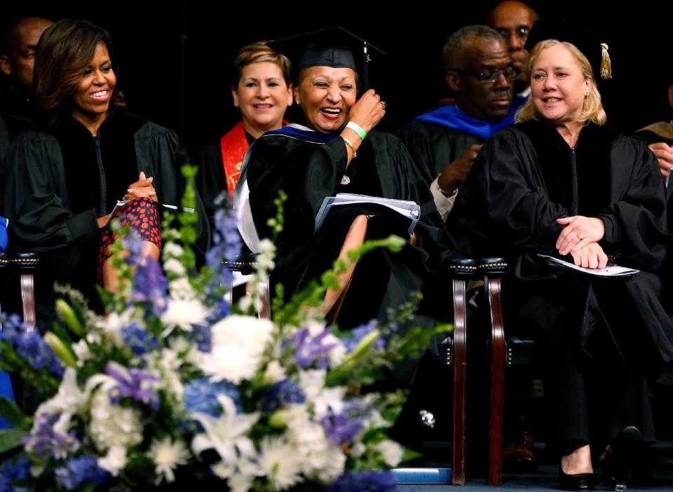 First lady Michelle Obama, left, Dillard's chair of the board of trustees Joyce M. Roche, center, and Sen. Mary L. Landrieu (D-La.) share a moment during Dillard University's commencement ceremony in New Orleans, Saturday, May 10, 2014. (AP Photo/Jonathan Bachman)
