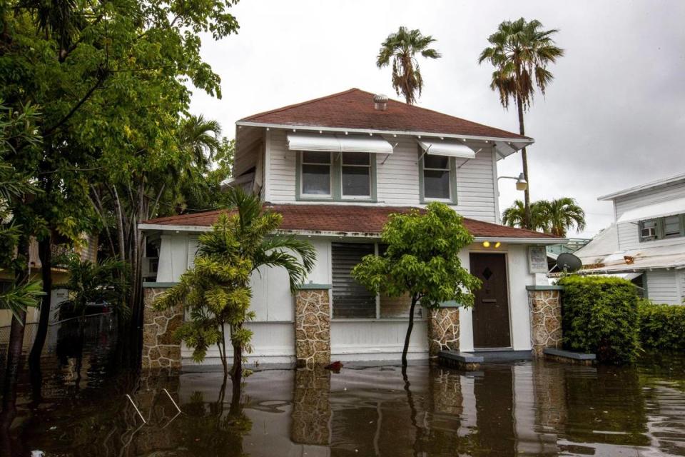 A house’s lawn is submerged under floodwaters off Southwest Third Street and Eighth Avenue in the Little Havana neighborhood of Miami, Florida, on Saturday, June 4, 2022. Lower homes like these are more at risk from flooding from sea level rise and nearby development at higher elevations.