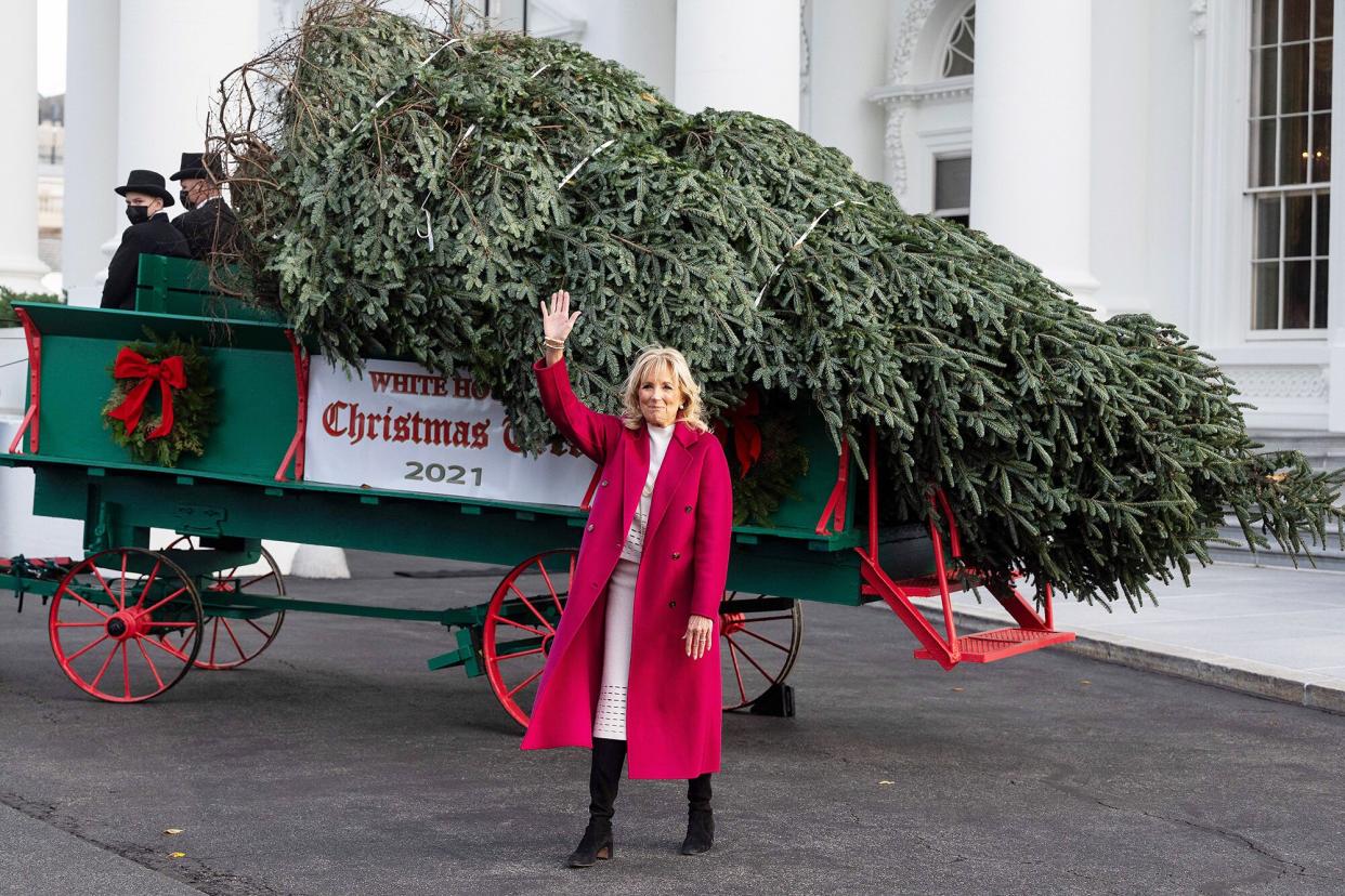 First Lady Jill Biden waves during the arrival of the White House Christmas Tree at the White House in Washington, DC, on November 22, 2021. (Photo by JIM WATSON / AFP) (Photo by JIM WATSON/AFP via Getty Images)
