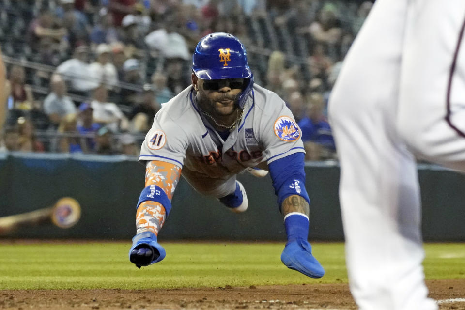 New York Mets' Jonathan Villar slides in head first to score a run against the Arizona Diamondbacks on a ball hit by James McCann in the second inning during a baseball game, Wednesday, June 2, 2021, in Phoenix. (AP Photo/Rick Scuteri)