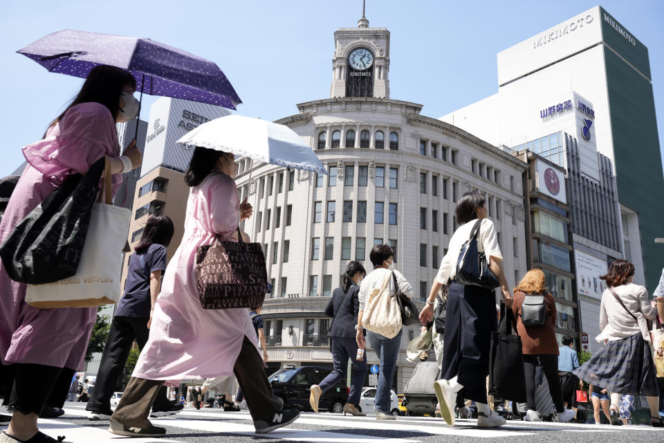 FILE - People cross a street in Tokyo on June 5, 2023. Wages are rising in Japan more than they have in decades, at least for some workers. But so are prices, leaving many people feeling they must scrimp more than ever.(AP Photo/Eugene Hoshiko)