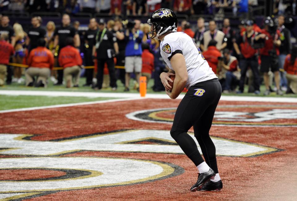 Feb 3, 2013; New Orleans, LA, USA; Baltimore Ravens punter Sam Koch (4) holds the ball in the end zone and takes a safety in the fourth quarter in Super Bowl XLVII against the San Francisco 49ers at the Mercedes-Benz Superdome. Mandatory Credit: Robert Deutsch-USA TODAY Sports