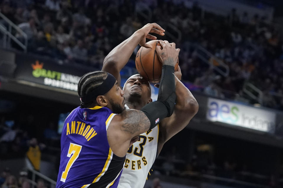 Indiana Pacers' Myles Turner (33) is fouled by Los Angeles Lakers' Carmelo Anthony (7) during the second half of an NBA basketball game Wednesday, Nov. 24, 2021, in Indianapolis. (AP Photo/Darron Cummings)