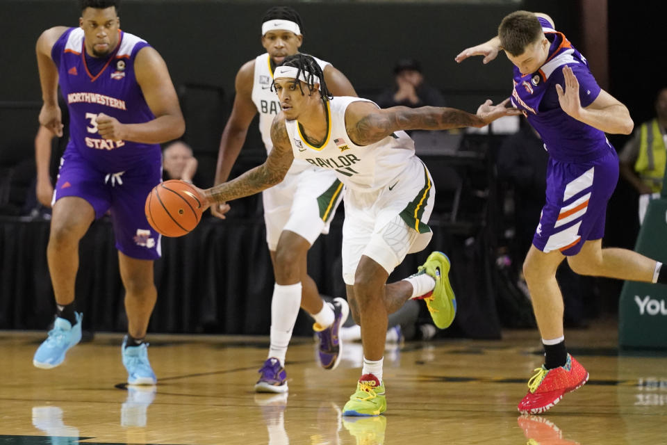 Baylor forward Jalen Bridges dribbles against Northwestern State guard Isaac Haney, right, and center Jordan Wilmore during the first half of an NCAA college basketball game in Waco, Texas, Tuesday, Dec. 20, 2022. Baylor won 58-48. (AP Photo/LM Otero)