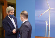 German Foreign Minister Heiko Maas, right, and the US' Special Presidential Envoy for Climate John Kerry, left, shake hands prior to a meeting at the Foreign Office in Berlin on Tuesday, May 18, 2021. (Odd Andersen/Pool Photo via AP)