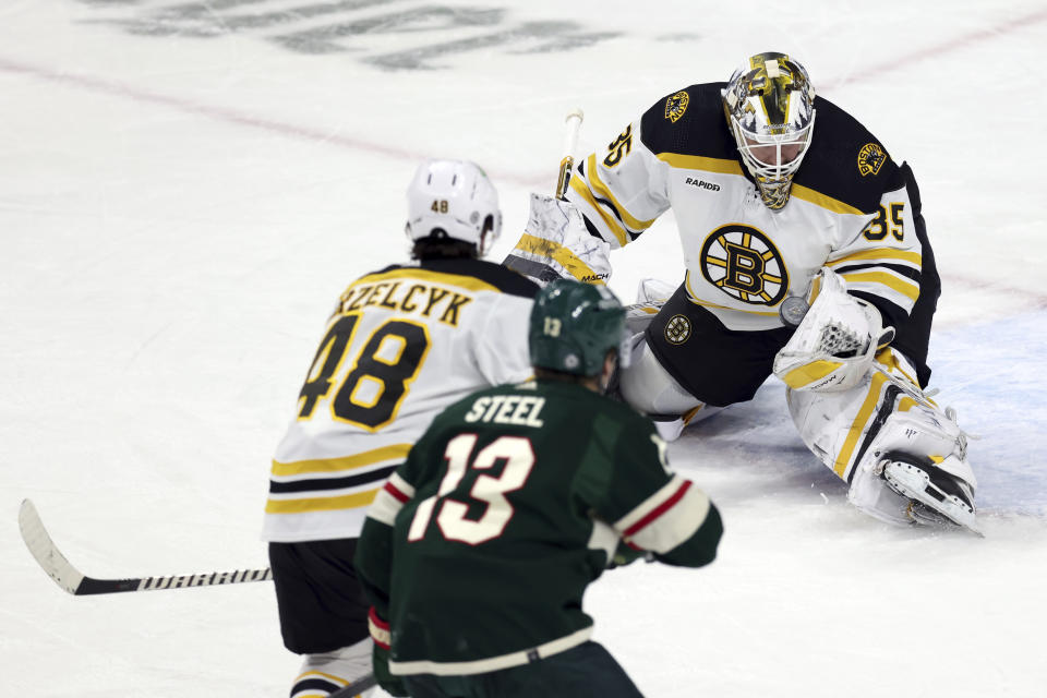 Boston Bruins goaltender Linus Ullmark (35) catches the puck during the first period of an NHL hockey game against the Minnesota Wild, Sunday, March 18, 2023, in St. Paul, Minn. (AP Photo/Stacy Bengs)