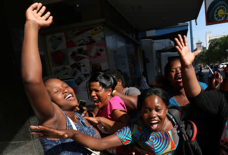 Zimbabweans celebrate in the morning sun after President Robert Mugabe resigned in Harare, Zimbabwe, November 22, 2017. REUTERS/Mike Hutchings