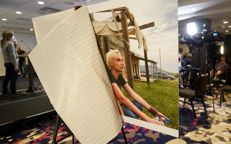  A photo of cinematographer Helyna Hutchins is displayed before a news conference by attorney Gary Dordick and his client Serge Svetnoy, chief of lighting on the "Rust' film set, to announce a lawsuit against Alec Baldwin and others, Wednesday, Nov. 10, 2021, in Beverly Hills, Calif. Svetnoy filed the lawsuit over Baldwin's fatal shooting of cinematographer Halyna Hutchins on the New Mexico set of the Western, alleging negligence that caused him "severe emotional distress" that will haunt him forever. (AP Photo/Damian Dovarganes)