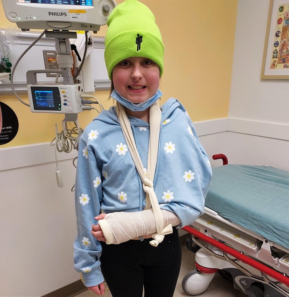 Nora Meek, 9, smiles after finding out she broke a bone in her arm. Nora was diagnosed with a brain tumor in September, and the treatment helping keep it stable has affected Nora's skeletal-muscular system.