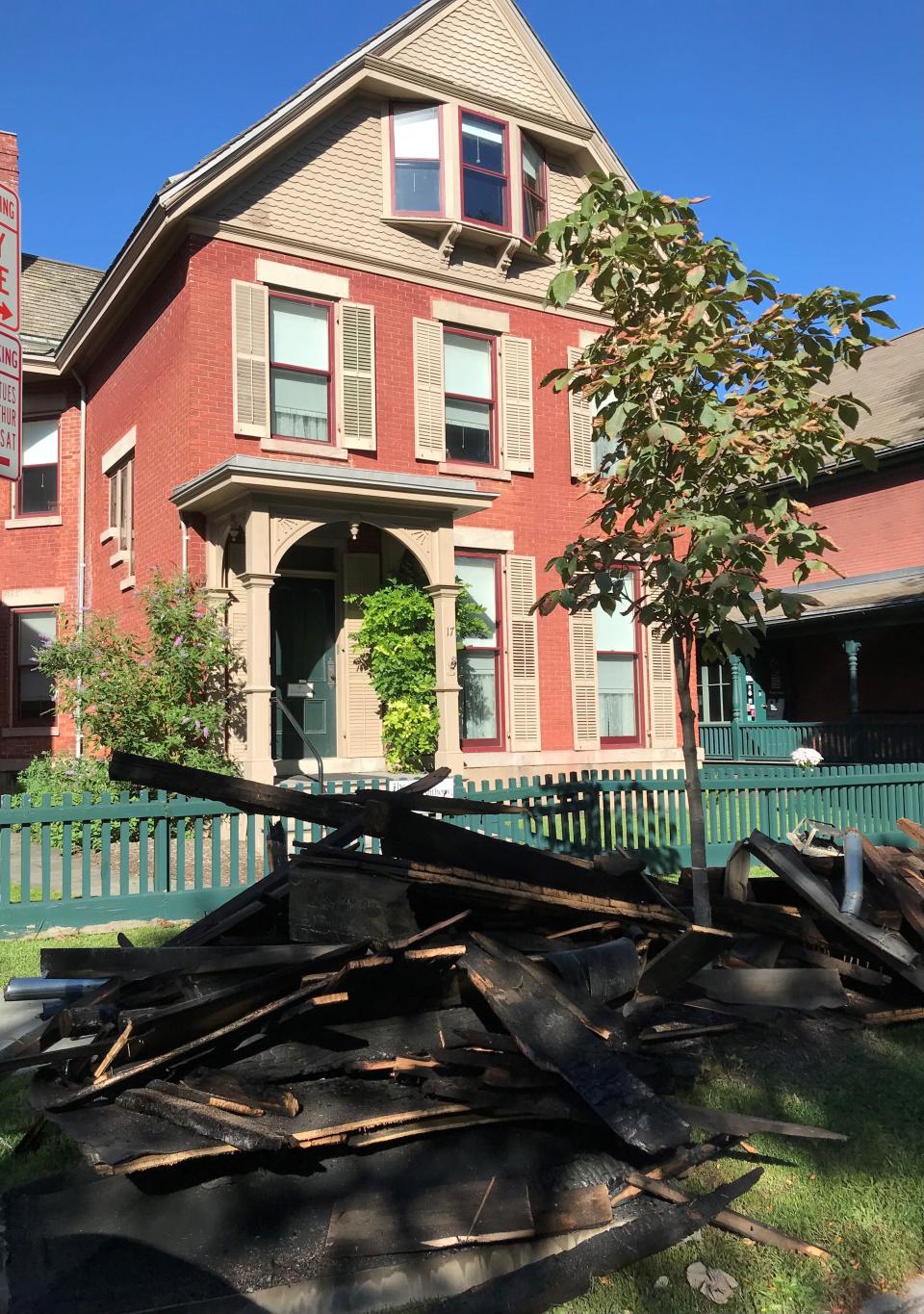 The charred remains of the back porch of the Susan B. Anthony Museum & House on Madison Street are curbside following a fire on Sept. 26, 2021.