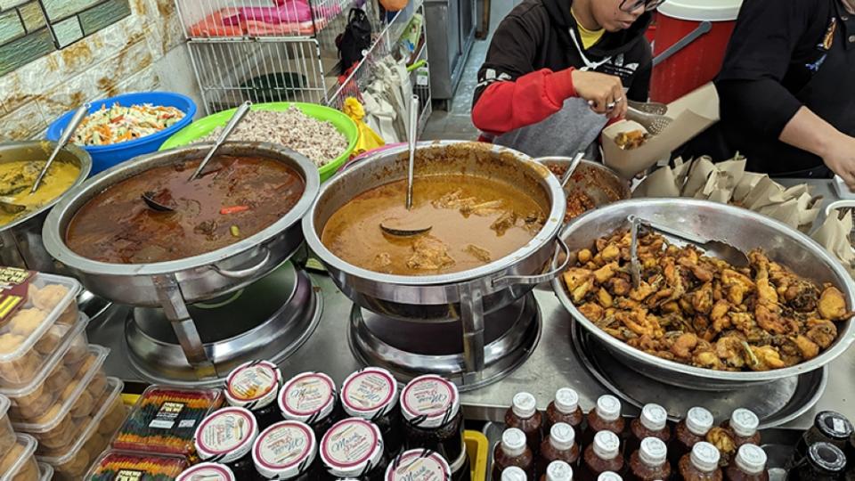 Massive bowls of fried chicken and pots of 'gulai' are a welcome view.