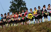 Members of the Miao minority group watch a performance in Biasha Village, Guizhou Province on February 4, 2014