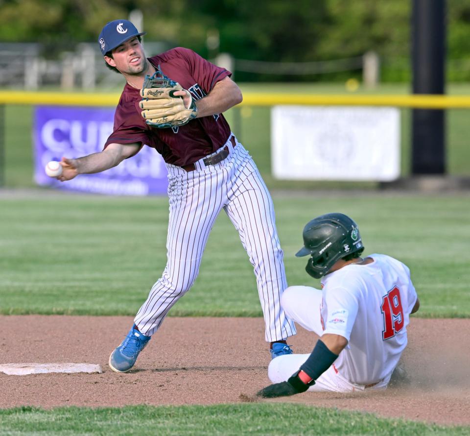 BOURNE 6/16/22  Cotuit second baseman Graham Pauley attempts to complete a double play as Ryan Leitch of Bourne slides in to break up the play.   Cape League baseball