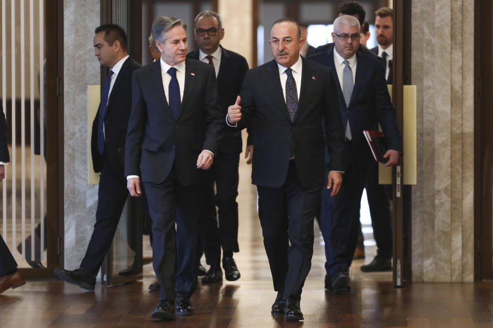 U.S. Secretary of State Antony Blinken, left, and Turkish Foreign Minister Mevlut Cavusoglu arrive for their meeting in Ankara, Turkey, Monday, Feb. 20, 2023. (AP Photo/Burhan Ozbilici)