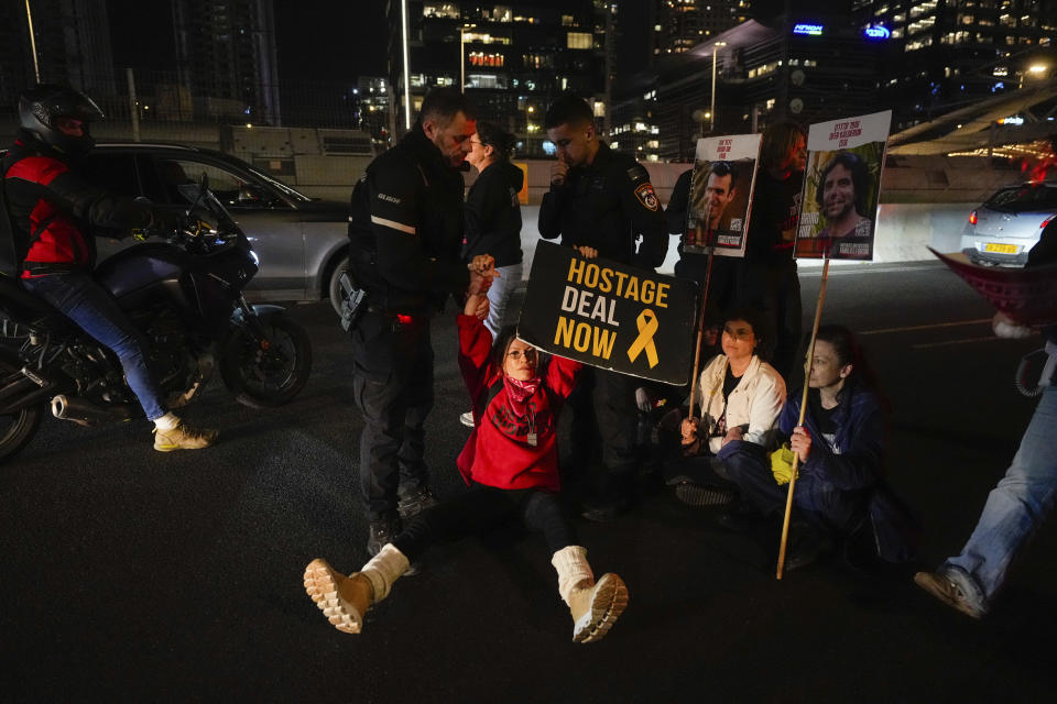 Israeli police officers disperse demonstrators blocking a highway during a protest calling for the release of hostages held in the Gaza Strip by the Hamas militant group in Tel Aviv, Israel, Tuesday, March 26, 2024. (AP Photo/Ohad Zwigenberg)