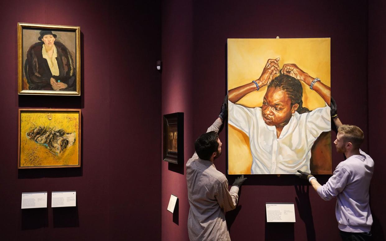 Gallery technicians Richard Carpenter (left) and Niall Fall (right) rehang Zipporah by Barbara Walke