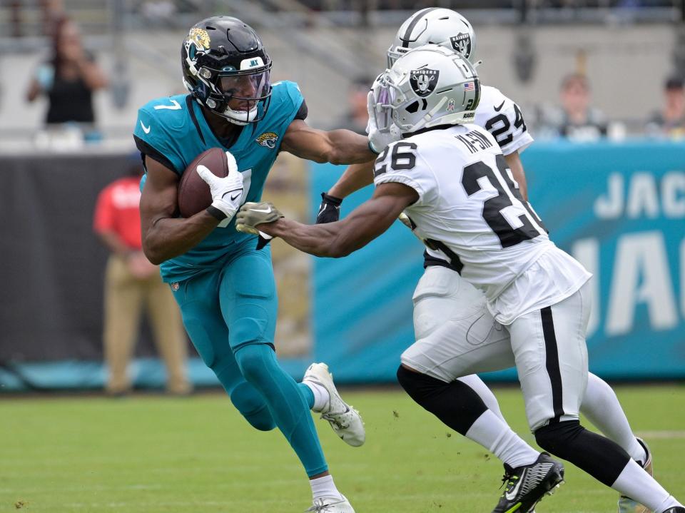 Zay Jones fights off a defender against the Las Vegas Raiders.