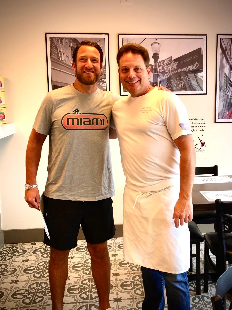 Dave Portnoy (left), founder of Barstool Sports and creator of "One Bite" pizza reviews, stands beside Jimmy Fantin, owner of Fantini's New Haven Style Apizza in Stuart, after reviewing his restaurant.