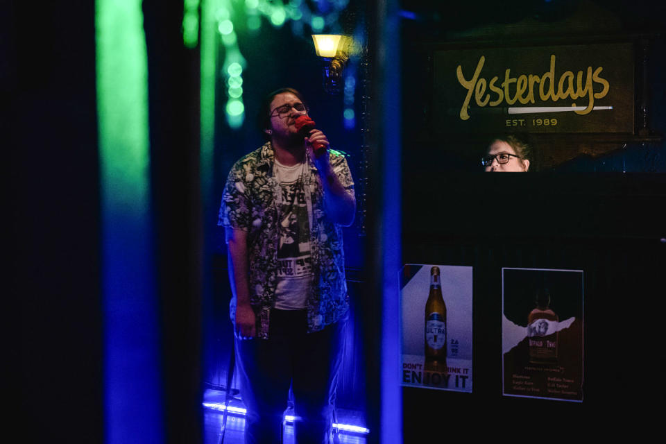 Oliver Bertasio sings at a karaoke bar (Jon Cherry for NBC News)