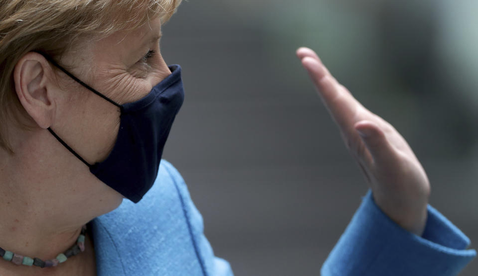 German Chancellor Angela Merkel waves as she leaves after her annual summer press conference in Berlin, Germany, Friday, Aug. 28, 2020. (AP Photo/Michael Sohn)