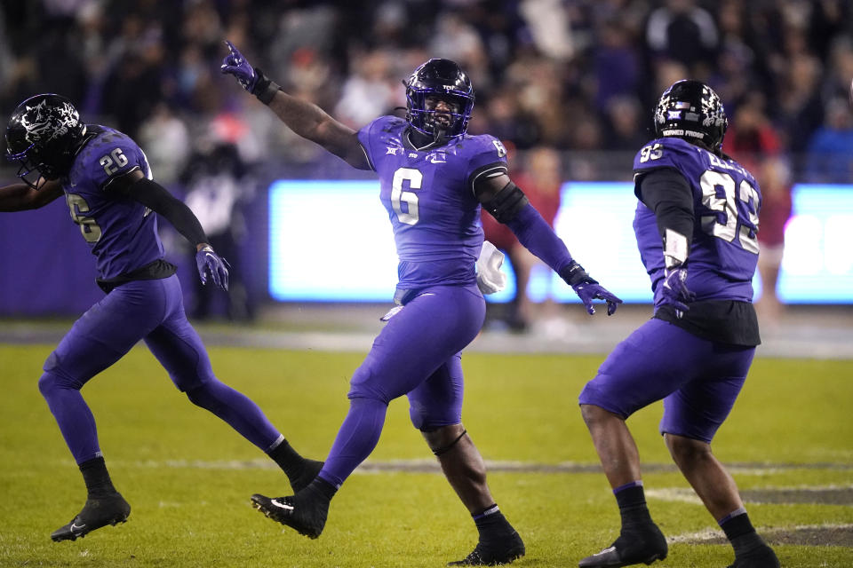 TCU linebacker Jamoi Hodge (6) celebrates a fumble recovery with teammates George Ellis III (93) and Bud Clark during the second half of an NCAA college football game against Iowa State in Fort Worth, Texas, Saturday, Nov. 26, 2022. TCU won 62-14. (AP Photo/LM Otero)