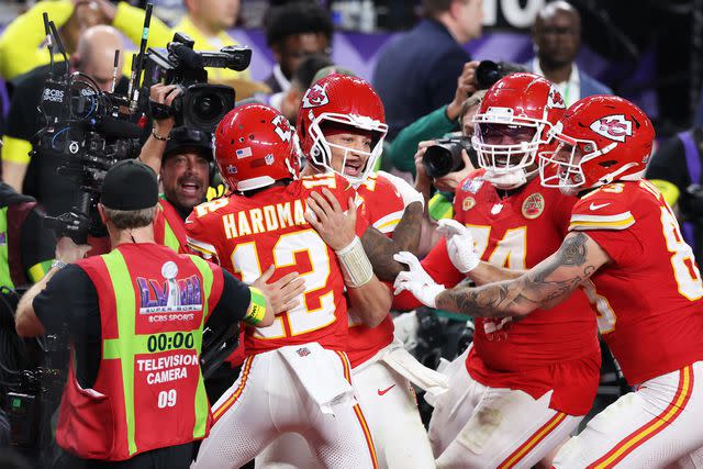 <p>Steph Chambers/Getty</p> Mecole Hardman Jr. #12 of the Kansas City Chiefs celebrates with Patrick Mahomes #15 after scoring the game-winning touchdown in overtime to defeat the San Francisco 49ers 25-22 during Super Bowl LVIII at Allegiant Stadium on February 11, 2024 in Las Vegas, Nevada.