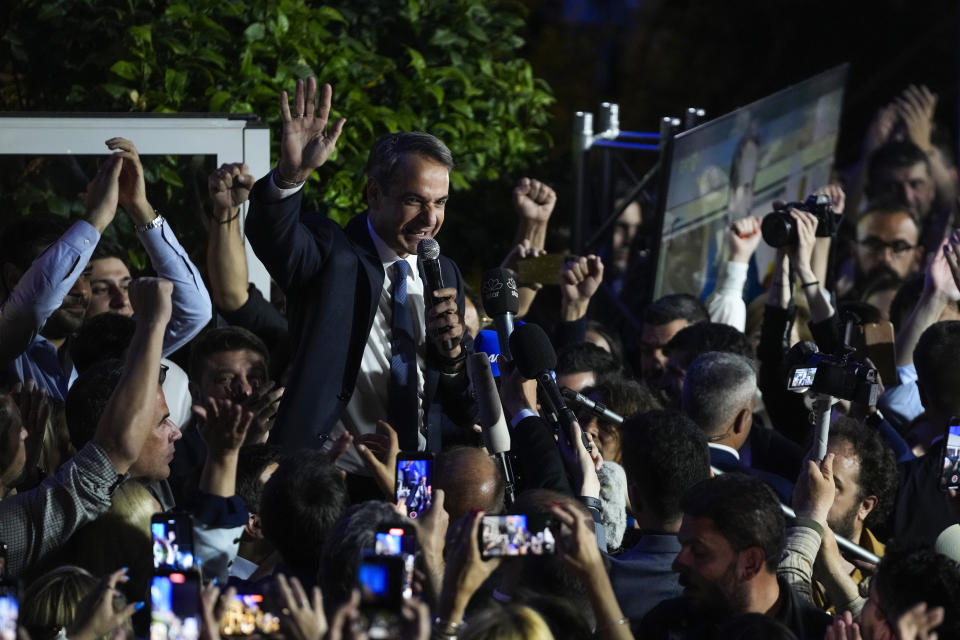 Greece's Prime Minister and leader of New Democracy Kyriakos Mitsotakis, center, addresses supporters at the headquarters of his party in Athens, Greece, Sunday, May 21, 2023. The conservative party of Greek Prime Minister Kyriakos Mitsotakis has won a landslide election but without enough parliamentary seats to form a government. (AP Photo/Thanassis Stavrakis)