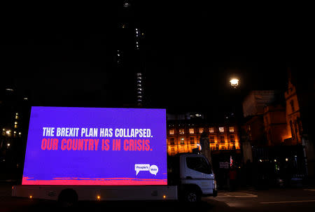 A truck with a sign passes by the Houses of Parliament after the result was announced on Prime Minister Theresa May's Brexit deal, in London, Britain, January 15, 2019. REUTERS/Clodagh Kilcoyne