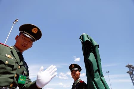 Paramilitary policemen gesture as they secure the venue of the Belt and Road Forum in Beijing, China, May 14, 2017. REUTERS/Damir Sagolj