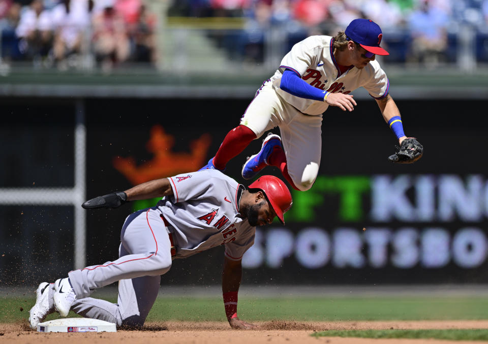 Philadelphia Phillies' Bryson Stott, top, leaps after a force-out to avoid the slide by Los Angeles Angels' Jo Adell, bottom, during the fourth inning of a baseball game, Sunday, June 5, 2022, in Philadelphia. (AP Photo/Derik Hamilton)