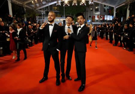 72nd Cannes Film Festival - Screening of the documentary film "Maradona" Out of Competition - Red Carpet Arrivals - Cannes, France, May 19, 2019. French hip-hop duo Bigflo et Oli (Florian and Olivio Ordonez) and their father Fabian pose. REUTERS/Stephane Mahe