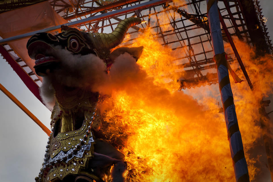 UBUD, BALI, INDONESIA - AUGUST 18: A black bull sarcophagus is set on fire during the Hindu Royal cremation of Anak Agung Rai Niang - also know as the Pengabenan - for the late Anak Agung Niang Rai, mother of Gianyar Regent, Tjokorda Oka Artha Ardana Sukawati, at Puri Ubud in Gianyar Bali on August 18, 2011 in Ubud, Bali, Indonesia. Niang Rai died in a Denpasar hospital in May; and will involve a nine level, 24m high 'bade' or body carring tower, made by upto 100 volunteers from 14 local villages. It will be carried to the cremation by 4500 Ubud residents. (Photo by Ulet Ifansasti/Getty Images)