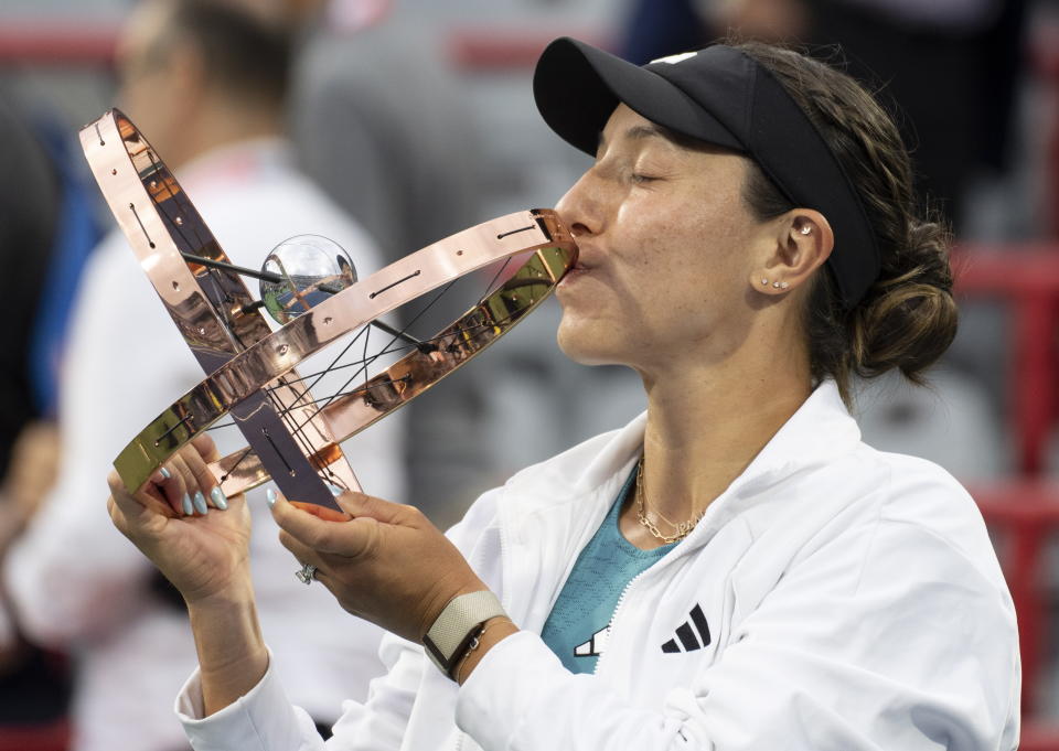 Jessica Pegula, of the United States, kisses the trophy following her win over Liudmila Samsonova, of Russia, in the women's final of the National Bank Open tennis tournament in Montreal, Sunday, Aug. 13, 2023. (Christinne Muschi/The Canadian Press via AP)