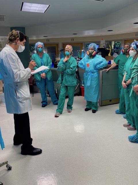 Dr. Jay Kaplan, left, speaks to medical staffers in New Orleans involved in the coronavirus fight during one of his "wellness visits," designed to mitigate trauma in health care workers.