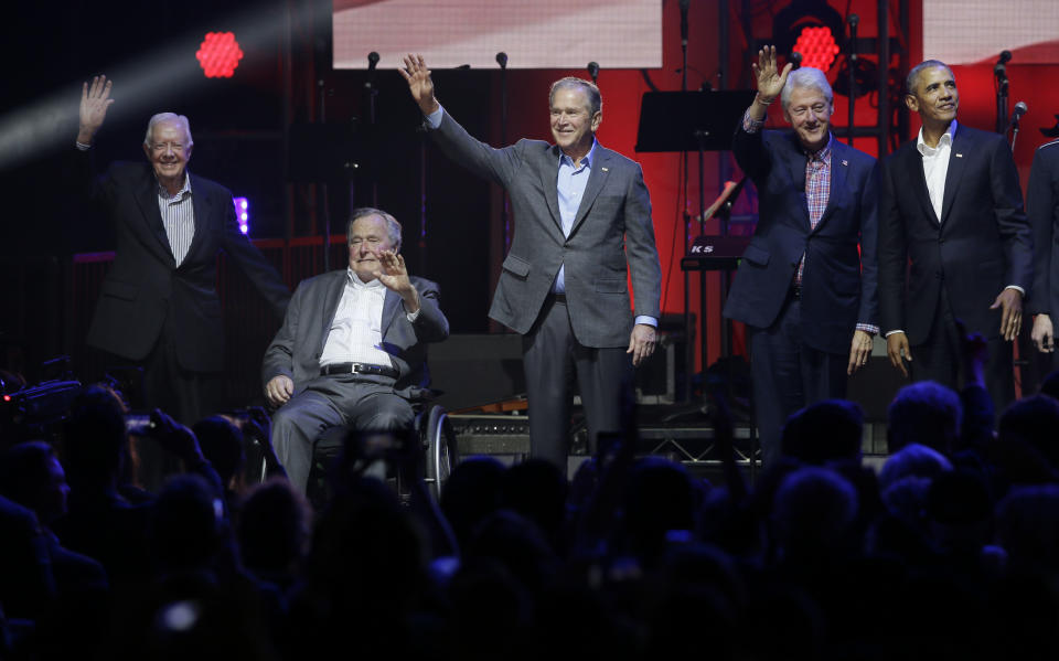 Former Presidents from right Barack Obama, Bill Clinton, George W. Bush, George H.W. Bush and Jimmy Carter wave on stage at the opening of a hurricanes relief concert in College Station, Texas, Saturday, Oct. 21, 2017. All five living former U.S. presidents joined to support a Texas concert raising money for relief efforts from Hurricane Harvey, Irma and Maria's devastation in Texas, Florida, Puerto Rico and the U.S. Virgin Islands. (AP Photo/LM Otero)