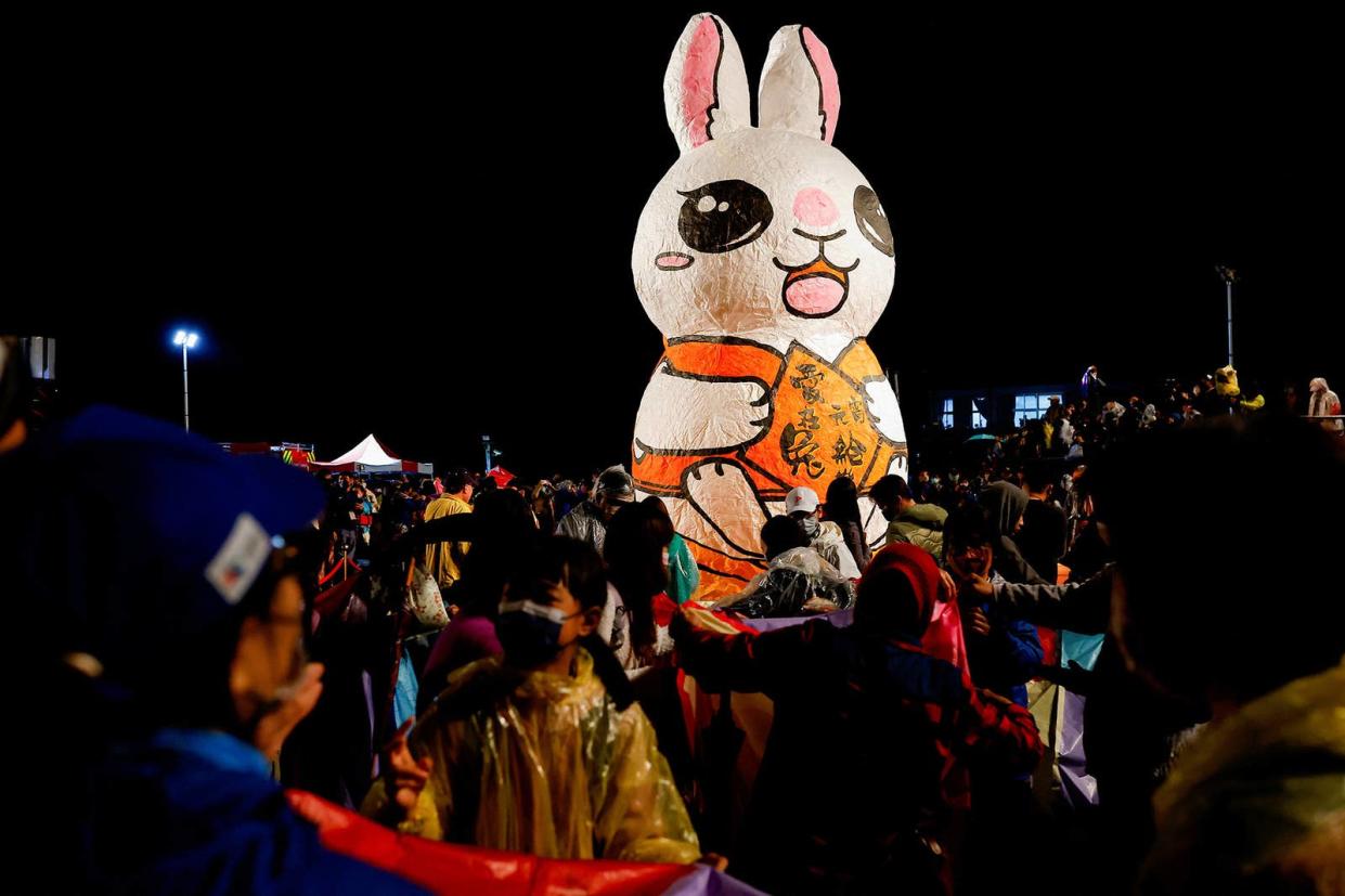 People gather near a rabbit-shaped lantern during the Lantern Festival, marking the end of the Lunar New Year celebrations in New Taipei City, Taiwan, on Feb. 5, 2023. 