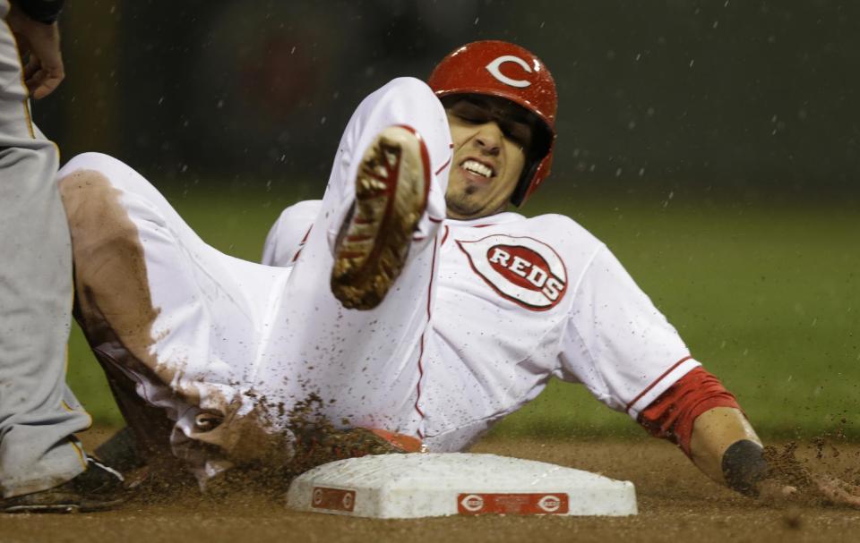 Cincinnati Reds' Neftali Soto advances to third on a sacrifice fly by Billy Hamilton in the fifth inning of a baseball game against the Pittsburgh Pirates, Monday, April 14, 2014, in Cincinnati. (AP Photo/Al Behrman)